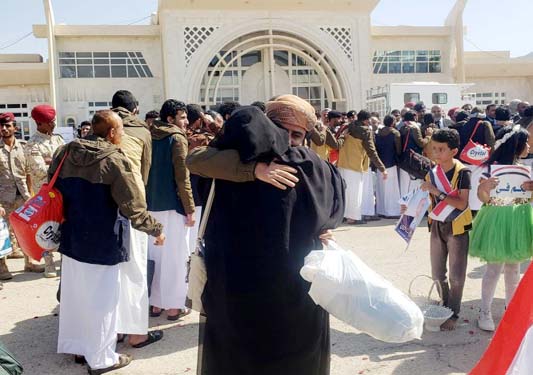 A freed Saudi-led coalition prisoner hugs a relative after his release in a prisoner swap, at Sayoun airport, Yemen on Thursday.