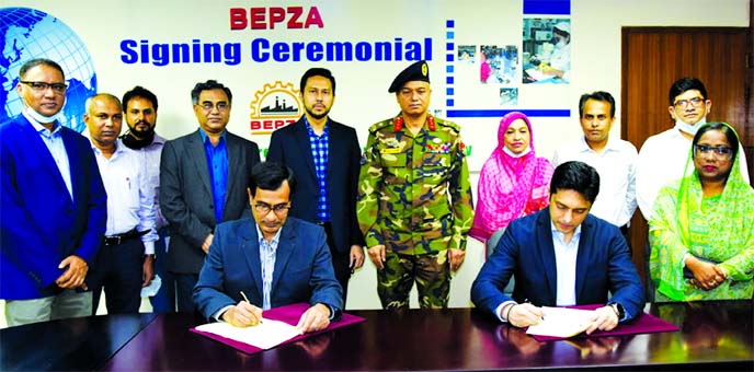 Md. Mahmudul Hossain Khan, Member (Investment Promotion) of BEPZA and Sharif Zahir, Managing Director of Z&Z Lingerie, exchanging agreement signing documents at BEPZA complex in the city on Thursday. Under the deal, Bangladeshi company Ms Z&Z Lingerie Li