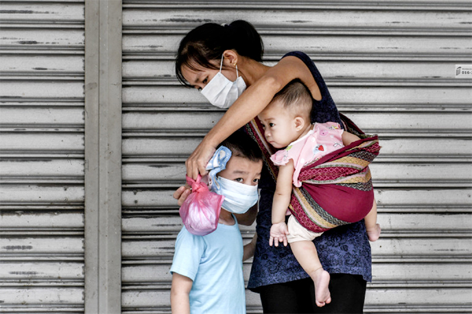 A refugee family in the city centre of Kuala Lumpur, Malaysia in May. Cuts in resettlement programmes mean many spend years waiting in limbo.