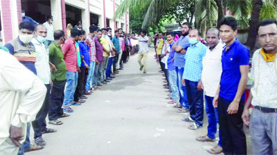 Members of Ainjibi Shohokari Samity form a human chain in front of Samity office in Jaipurhat on Thursday protesting assaults on one of their fellow by a lawyer.