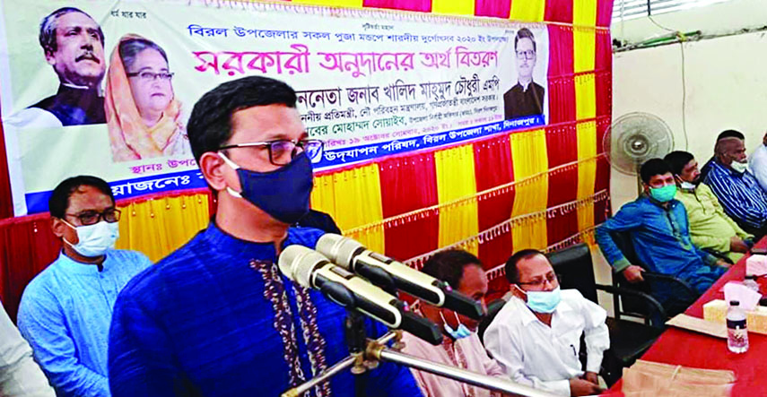 State Minister for Shipping Khalid Mahmud Chowdhury speaks at the distribution of Government's financial assistance at Puja Mandaps in Biral Upazila on Monday on the occasion of Durga Puja organised by Bangladesh Puja Udjapon Parishad, Biral Upazila.