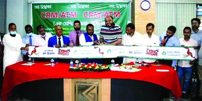 Sikder Mohammad Shihab, Sylhet Zonal Head of Islami Bank Bangladesh Limited (IBBL) and Ataullah Sarker, owner of Karimullah Market, inaugurate IBBL's CRMATM booth at the market place in Sylhet city on Wednesday.