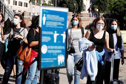 People wearing face masks queue to buy tickets to enter the Colosseum as Italy is facing a surge in the coronavirus infections in Rome, Italy on Thursday.