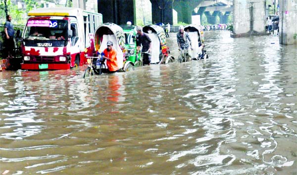 Vehicles wade through as incessant rains caused water-logging in different areas of Chattogram due to depression. This photo was taken from 2nd Gate area on Friday.