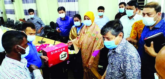 M. Ubaidul Muktadir Chowdhury (MP), distributes sewing machines among the registered fishermen in Bijoynagar upazila of Brahmanbaria at the initiative of Fisheries Department of the district at a ceremony on Thursday.