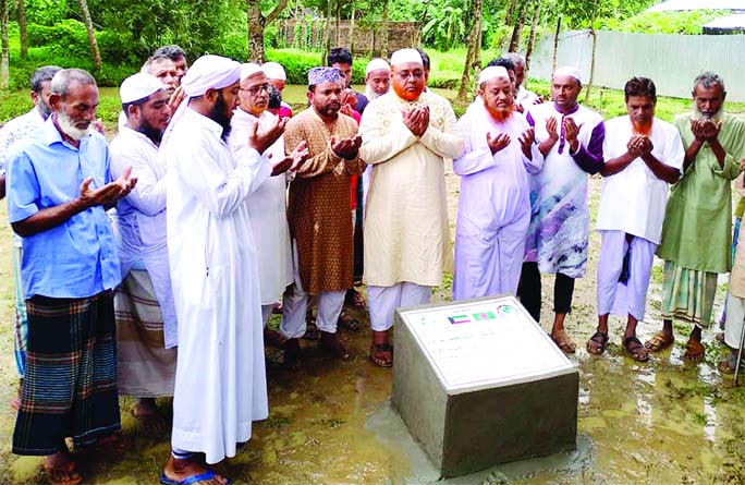 Md Golam Kibria, Mayor of Fulbari Pourashava along with local people offer Doa after laying foundation stone of Hazipara Jam-e-Mosque at 4-No Ward Panch-Kushmail in Fulbari of Mymensingh district on Saturday.