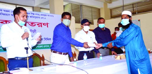 Paban Chowdhury, Executive Chairman of the Bangladesh Economic Zone Authority (BEZA) distributes cheques among the victims of land acquisition for Bangabandhu Sheikh Mujib Industrial City at a ceremony organized by the Chattogram district administration a