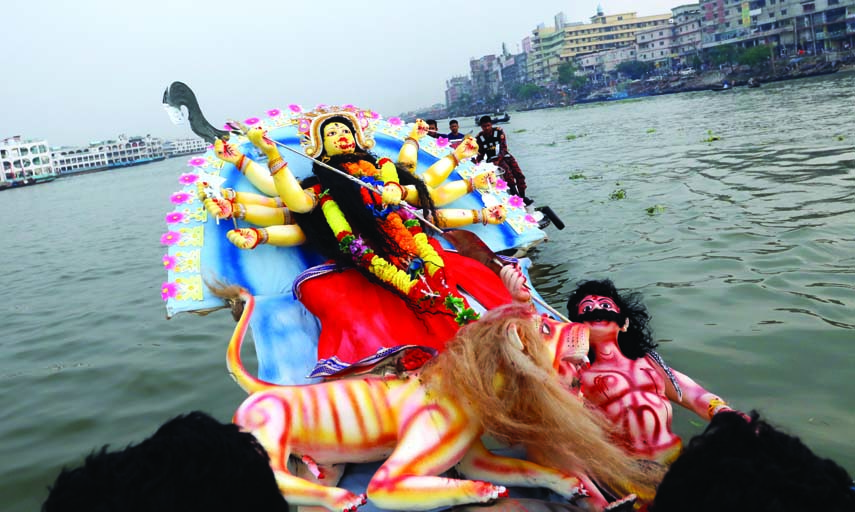 Hindu devotees immerse images of Goddess Durga in the Buriganga River on the occasion of Bijoya Dashami on Monday.