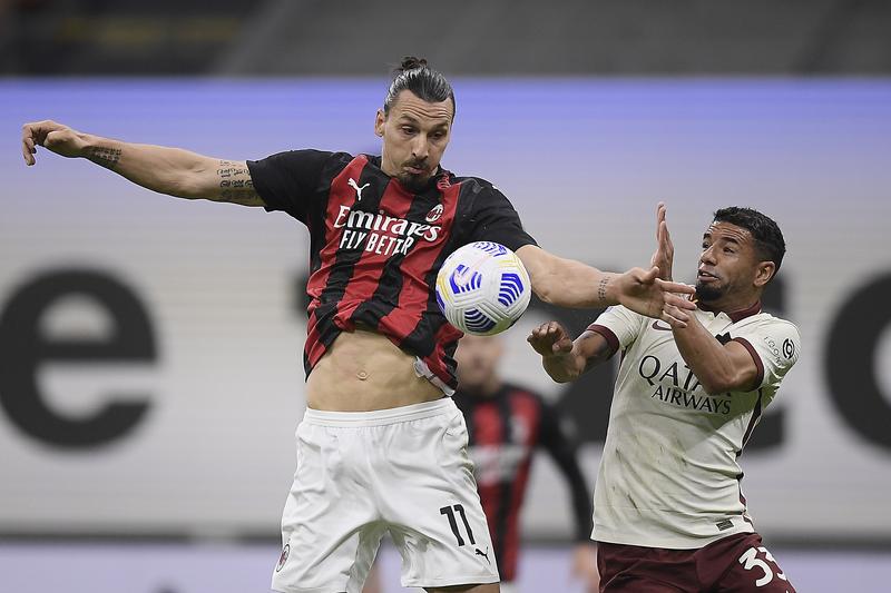 AC Milan's Zlatan Ibrahimovic (left) and Roma's Bruno Peres vie for the ball during the Serie A soccer match between AC Milan and Roma at the Milan San Siro Stadium, Italy on Monday.