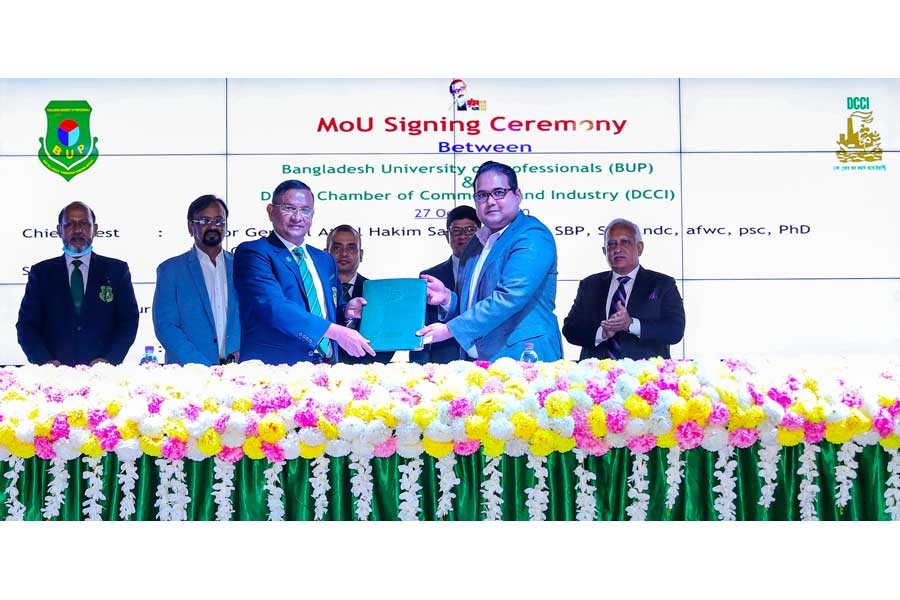 Dhaka Chamber of Commerce & Industry (DCCI) President Shams Mahmud and Vice Chancellor of Bangladesh University of Professionals (BUP) Major General Ataul Hakim Sarwar Hasan, exchanging an agreement signing documents on behalf of their respective organisa