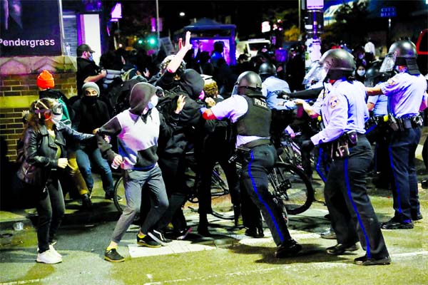 Protesters scuffle with riot police during a protest against police brutality in Philadelphia, Pennsylvania on Tuesday.