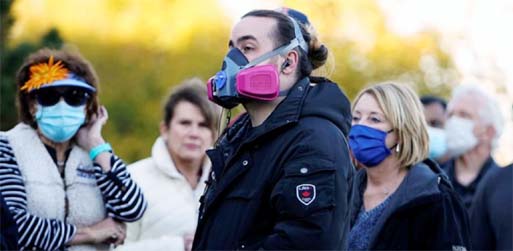 Voters wearing face masks due to the ongoing coronavirus outbreak, wait in a nearly four hour long line to cast their ballots during early voting at a polling site in Edmond, Oklahoma, US.
