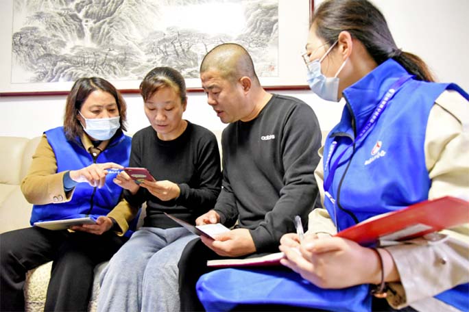 Census workers collect information from residents in Lianyungang, in China's eastern Jiangsu province.