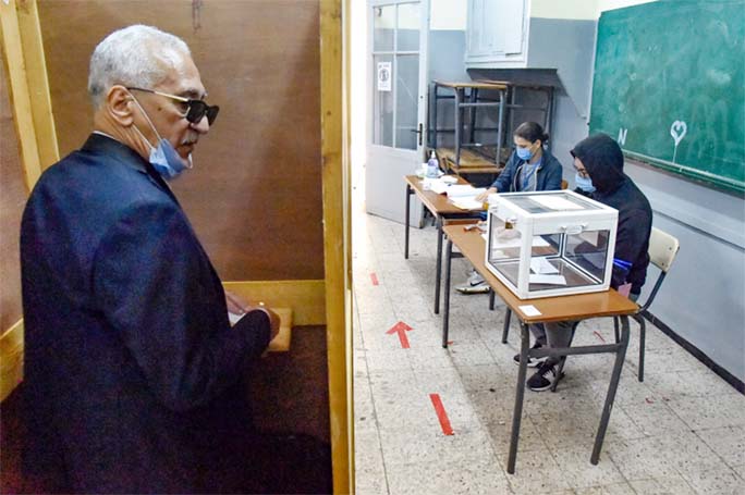 An Algerian man prepares to vote at a polling station in the capital Algiers during a vote for a revised constitution.