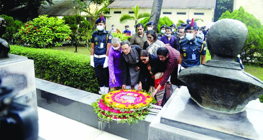 Family members pay floral tributes at the portraits of four slain national leaders at the Old Central Jail in the city on Tuesday marking the Jail Killing Day.