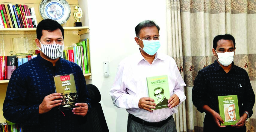 Information Minister Dr. Hasan Mahmud unwraps the cover of three books at his residence in the city on Tuesday marking Jail Killing Day.