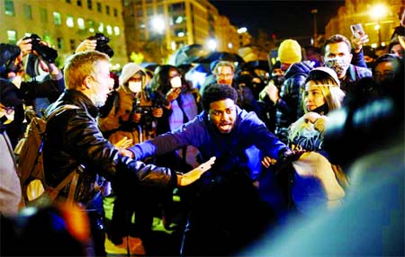 Men gesture as protesters gather at Black Lives Matter Plaza near the White House in Washington, US, on Tuesday.