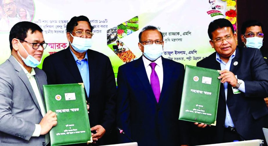 Agriculture Minister Dr Abdur Razzaque and LGRD and Cooperatives Minister Tajul Islam at the signing ceremony of MoU between Agriculture Ministry and Local Government Division about the construction of farmers' training centers in 106 upazilas at the con