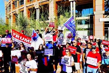 Supporters of US President Donald Trump hold signs and chant slogans during a protest about the early results of the 2020 presidential election, in front of the Phoenix City Hall, in Phoenix, Arizona on Thursday.