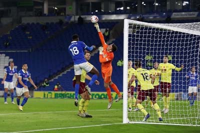 Burnley's goalkeeper Nick Pope (center) makes a fingertip save as Brighton's striker Danny Welbeck (left) closes in during the English Premier League football match between Brighton & Hove Albion and Burnley at the American Express Community Stadium in