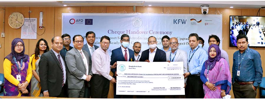 Abu Farah Md. Nasser, Executive Director of Bangladesh Bank handing over a cheque under a project specially designed to strengthen economic sustainability of the RMG sector named "Program to Support Safety Retrofits and Environmental Upgrades in the Bang