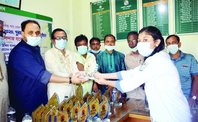 Fahmi Golandaj Babel, MP, distributes prize to a winner of 'Bangabandhu Rachna Competition' organized on the occasion of Mujib's Centenary at a ceremony held at the Gafargaon Press Club on Saturday.