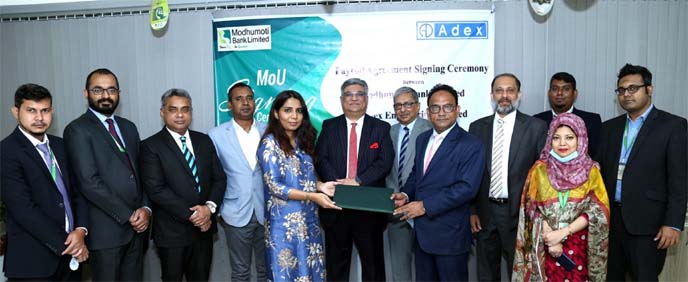 Md. Shaheen Howlader, Head of Corporate & Investment Banking Division of Modhumoti Bank Limited and Tarana Ali, Vice Chairman of Adex Group, exchanging a MoU signing document at the bank's Mirpur branch on Thursday. Under the deal, employees of Adex Grou