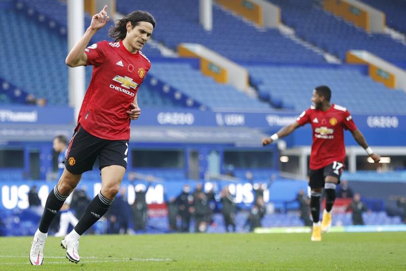 Manchester United's Edinson Cavani (left) celebrates after scoring his side's third goal during the English Premier League soccer match against Everton at the Goodison Park stadium in Liverpool, England on Saturday.