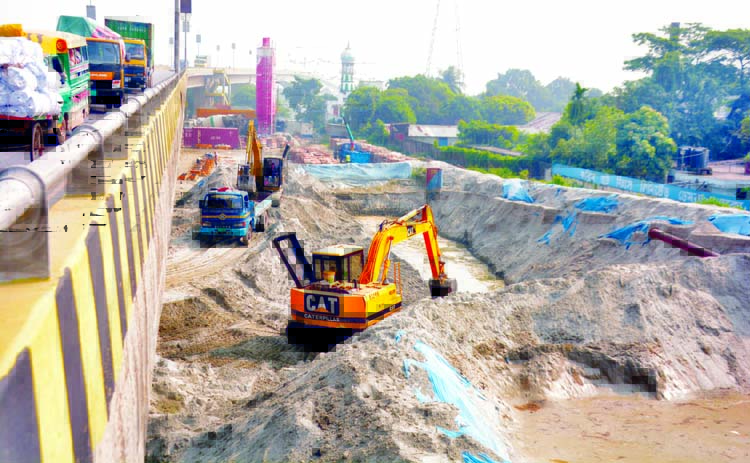 After being evicted from Kanchpur area, the sand traders continue their illegal business under Sultana Kamal Bridge at Demra in the city. The photo was taken on Sunday.