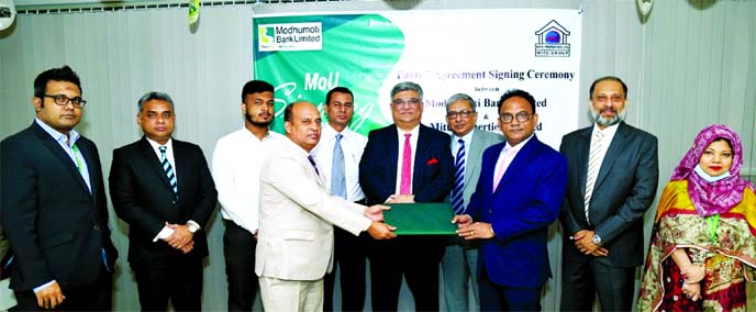 Md. Shaheen Howlader, Head of Corporate & Investment Banking Division of Modhumoti Bank Limited and Md. Moshiur Rahman Chowdhury, Managing Director of Mitu Properties Limited, exchanging agreement signing document at the banks head office in the city rece