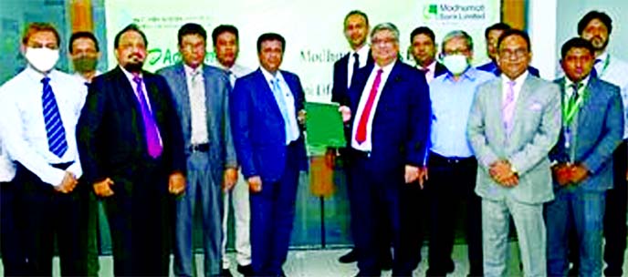 Md. Shafiul Azam, Managing Director of Modhumoti Bank Limited and Nemai Kumar Saha, CFO of Sandhani Life Insurance Company Limited, exchanging an agreement signing document at the banks head office in the city recently. Under the deal, clients of the insu
