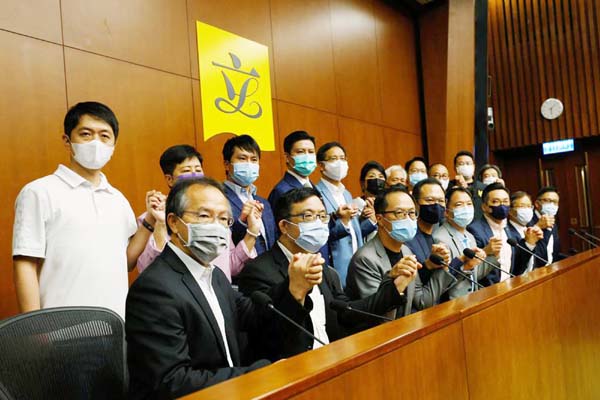 Pan-democratic legislators including Alvin Yeung, Dennis Kwok and Wu Chi-wai join their hands during a news conference as they threat with mass resignations amid reports on Beijing plans to disqualify four opposition lawmakers, in Hong Kong, China.