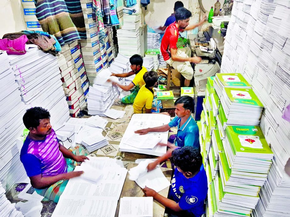 Binders are passing busy time to get ready the school text books those are scheduled to distribute among the students on the 1st day of coming year, January 1, 2021.