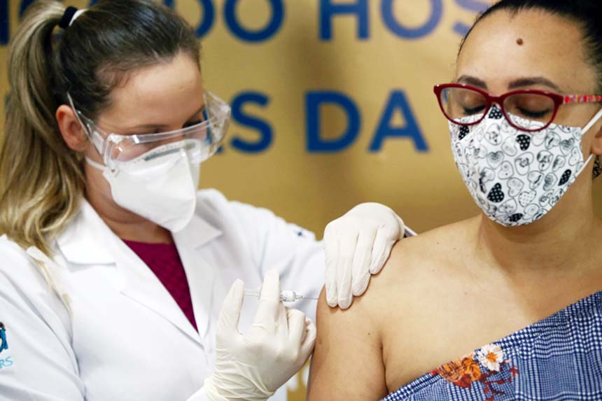 Nurse Isabelli Guasso administers China's Sinovac, a potential coronavirus vaccine, to a volunteer, nurse Fabiana Souza, at Sao Lucas Hospital in Porto Alegre, Brazil.