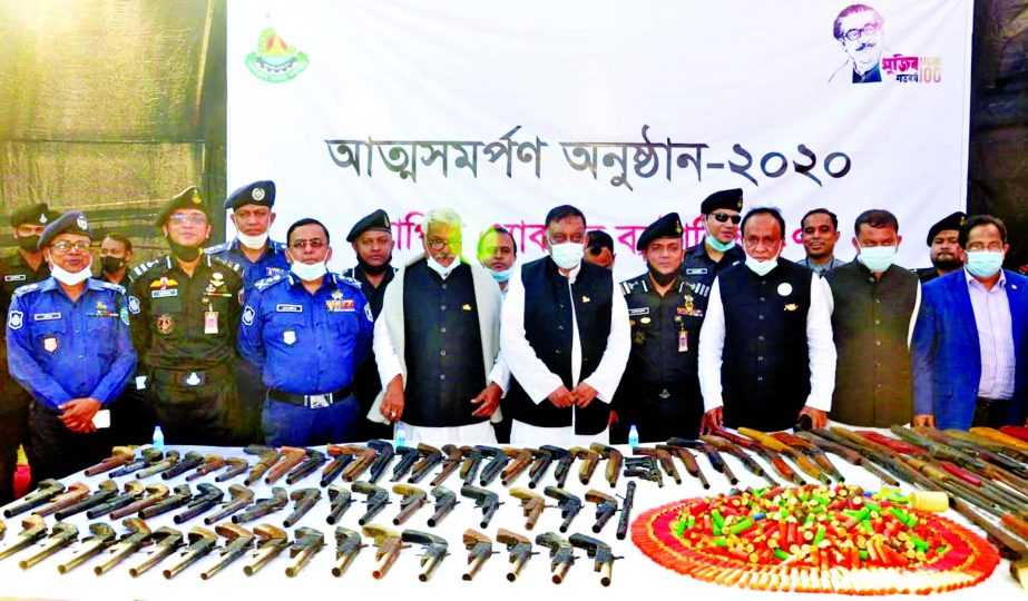 Robbers lay down 90 locally-made firearms and 2056 bullets before the Home Minister Asaduzzaman Khan Kamal at Banshkhali area in Chattogram on Thursday during their surrender to Rapid Action Battalion (RAB). Md Shamsul Haque Tuku, Chairman of Parliament