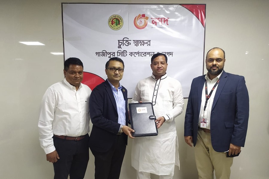 Executive Director of Nagad Md Shafayet Alam (second from left) and GCC Mayor Mohammad Jahangir Alam (second from right) seen exchanging documents on behalf of their respective organisations Executive Director of Nagad Md Shafayet Alam (second from left)