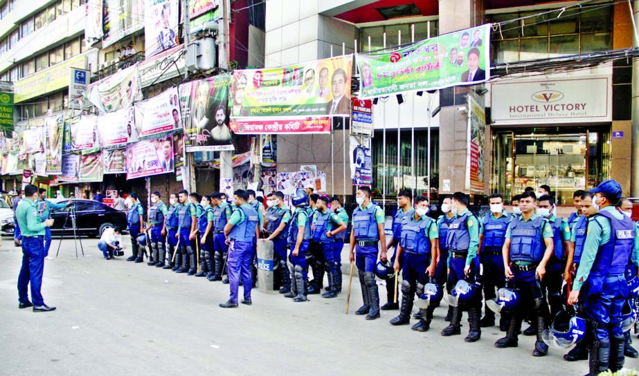 Police take position in front of the Nayapaltan central office of BNP after seven buses were torched in different parts of the capital on Thursday.