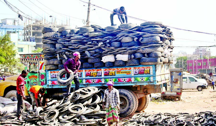 Abandoned tyres and tubes are being loaded in a truck at Kamrangir Char in the capital on Saturday, which would be brunt to produce fuel oil. Besides, those are also be used in brick kilns. Toxic fumes to be produced from burning tyres would ultimately po