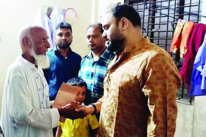 Municipal Mayor SA.M. Ikbal Hossain Sumon hands over a cheque of Tk. 50,000 to former MP Enamul Hoque (Judge Miah) on Saturday.