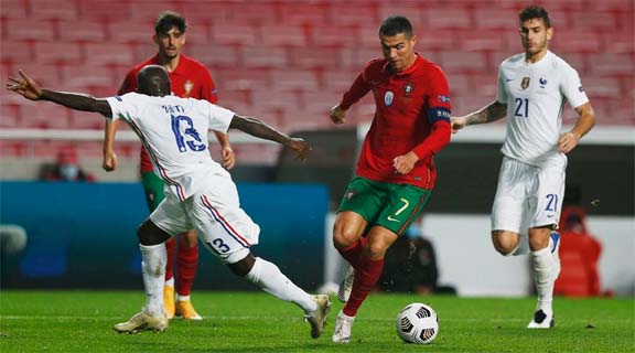 Portugal's Cristiano Ronaldo (2nd from left) in action with France's N'Golo Kante during the UEFA Nations League soccer match between Portugal and France at the Luz stadium in Lisbon on Saturday.