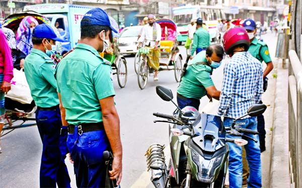 Police gear up checking of transport and vehicles following arson attack on dozen of buses on Thursday last--the day of Dhaka-18 by-polls. The photo was taken from city's Hatkhola Road on Monday.
