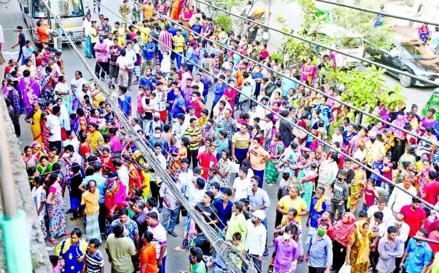 The panic-stricken people rush to the street after fire breaks out at Sweeper Colony in the city's Swamibagh on Monday.