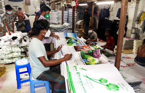 Workers are passing busy time for binding calander ahad of New Year- 2021. The picture was taken from a press in citys Banglabazar area on Tuesday.