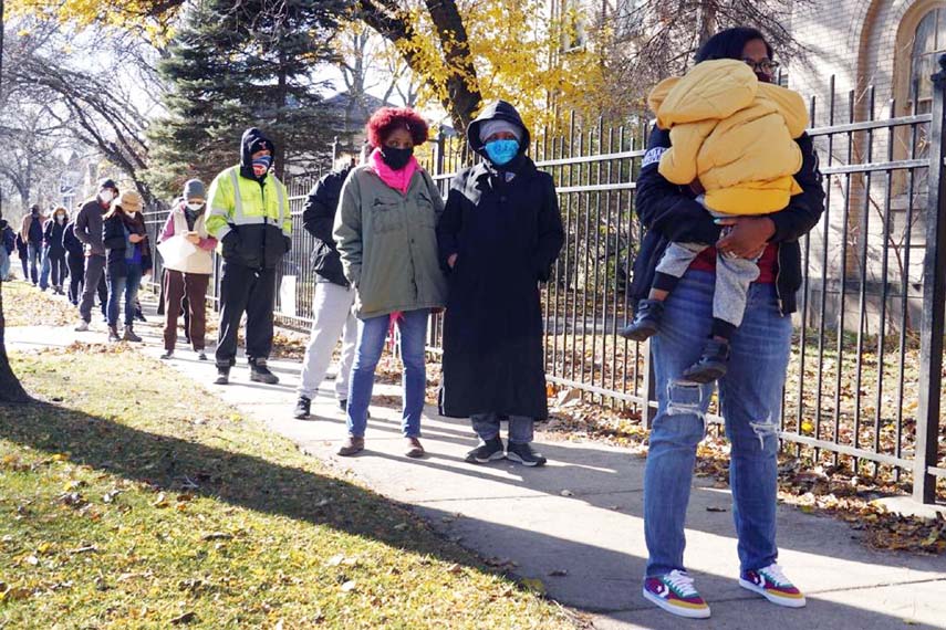 Residents wait in line for Covid-19 tests at a test site at St Benedict the African Catholic Church in the Englewood neighborhood, in Chicago, Illinois.