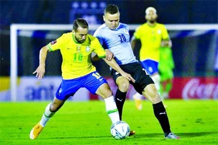 Brazil's Everton Ribeiro (left) and Uruguay's Jonathan Rodriguez vie for the ball during their closed-door 2022 FIFA World Cup South American qualifier football match at the Centenario Stadium in Montevideo on Tuesday.