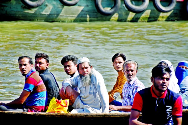 Defying government's instruction, people are ferrying through riverine route by boat on the Buriganga River on Thursday without wearing any mask and also showing total disregard to social distancing in the wake of Covid-19 2nd wave.