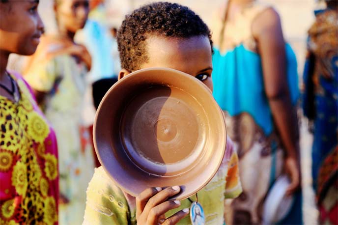 An Ethiopian child who fled war in Tigray queues for food at the Um-Rakoba camp, on the Sudan-Ethiopia border.