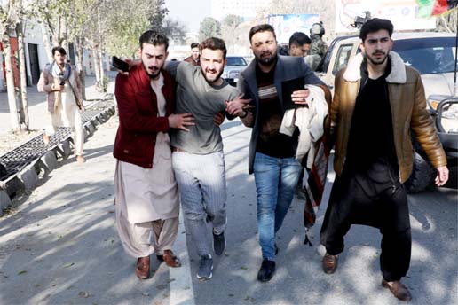 A wounded man is carried as he leaves a hospital after a barrage of rockets hit residential areas in Kabul on Saturday.