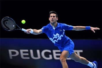 Serbia's Novak Djokovic returns to Germany's Alexander Zverev (not in picture) during their men's singles round-robin match on day six of the ATP World Tour Finals tennis tournament at the O2 Arena in London on Friday.