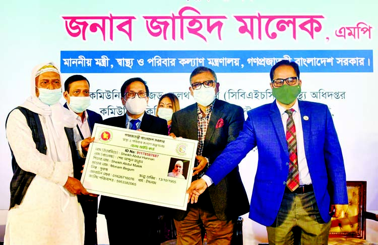 Health Minister Zahid Maleque distributes Individual Health ID Card at Hotel Sonargaon in the capital on Sunday.